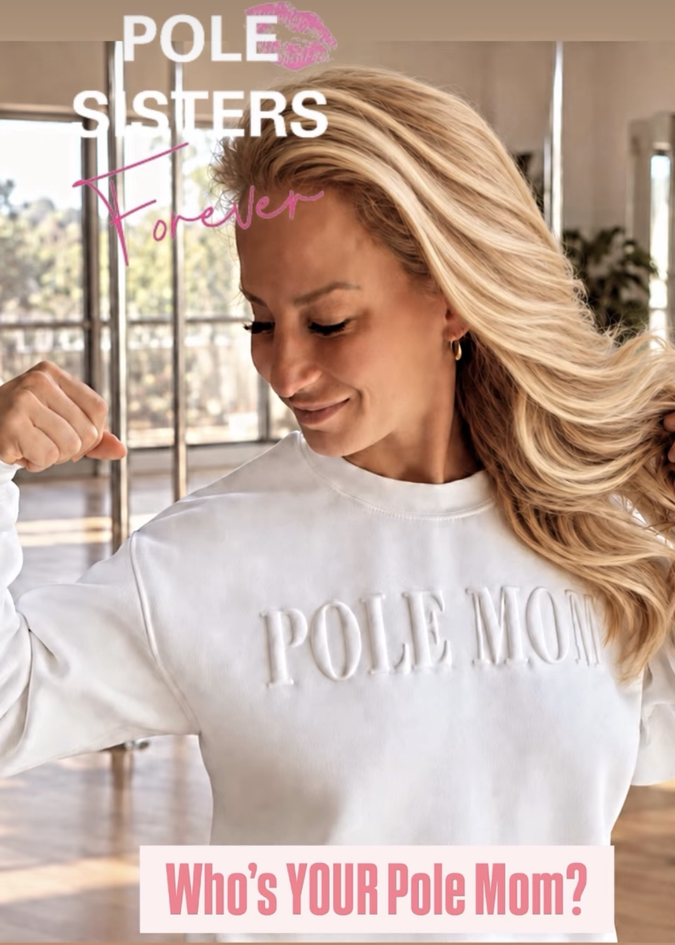 April wearing the white Pole Mom crewneck in a pole studio — Who’s YOUR Pole Mom?